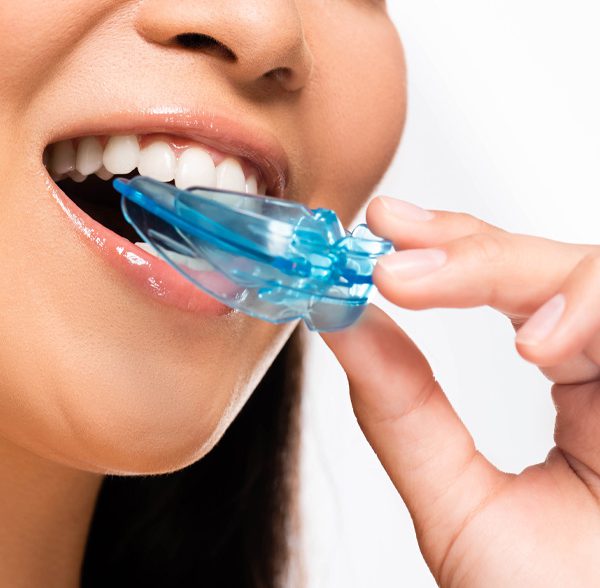 Woman using mouth guard